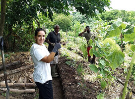 Group standing in vegetable garden 