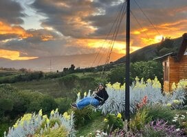 Ecuador intern on a swing enjoying sunset