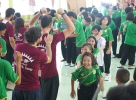 Volunteers playing games with the kids at school