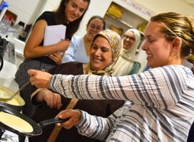 Student cooks baghrir with Darija teacher