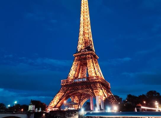 The Eiffel Tower lit up at night 