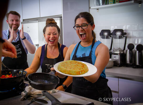 A proud student after cooking a Spanish dish