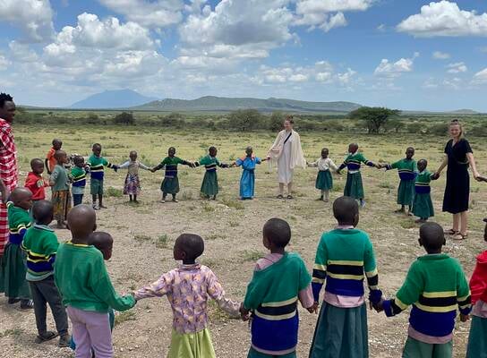 volunteer teachers playing with the students after a break from teaching 