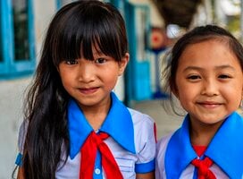 Happy Vietnamese schoolgirls on a schoolyard, South Vietnam