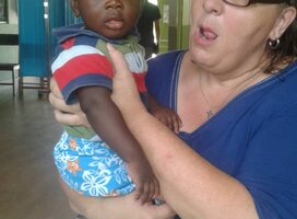 GXVO volunteer taking care of a child