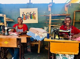 Women learning tailoring from our workshop