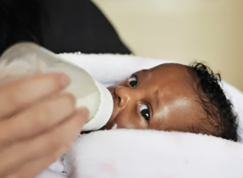 Volunteer bottle feeding a baby