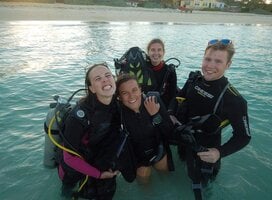 Divers pose in a pool