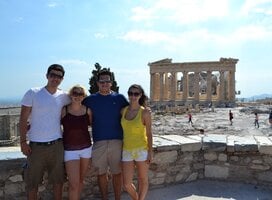 Students smiling in front of the Parthenon