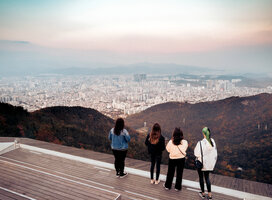 Four students overlooking beautiful city