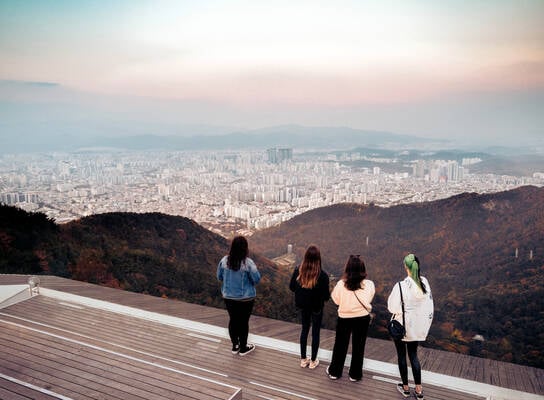 Four students overlooking beautiful city