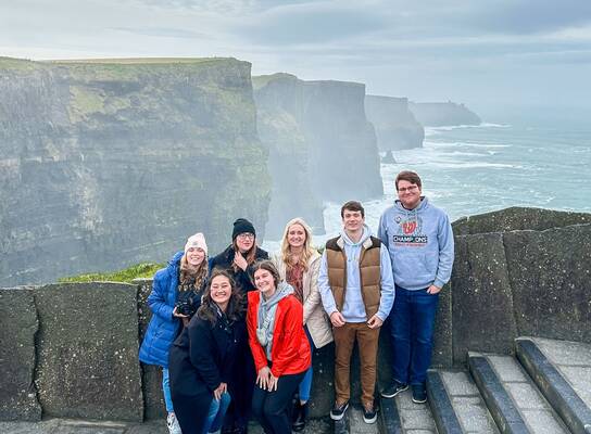 Participants gather in front of a beautiful view