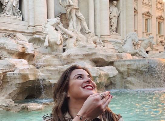 Participant throws a coin into the Trevi Fountain