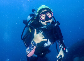 Student is scuba diving and giving a thumbs up