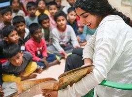 Volunteer reading to children.