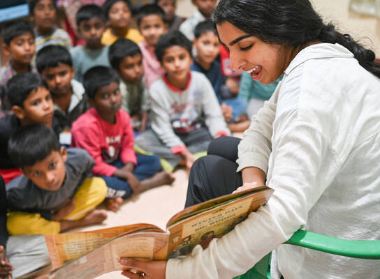 Volunteer reading to children.