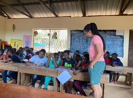 A dedicated volunteer sharing knowledge and inspiring young minds at Arloste Ganze Foundation.