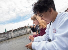 Students leaning on bridge
