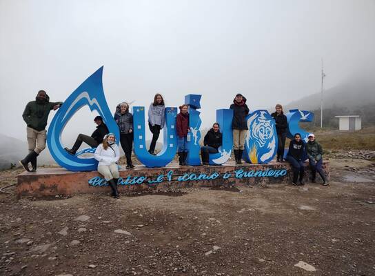 Students in Front of Quijos Sign