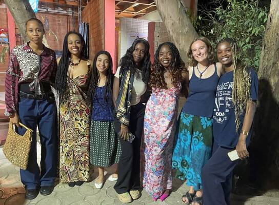 6 smiling students in traditional west african tissues and dress in Dakar, Senegal. 