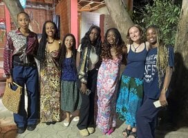 6 smiling students in traditional west african tissues and dress in Dakar, Senegal. 