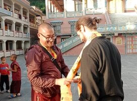 Senior monks giving bless to Volunteer  