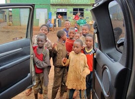 the children are welcoming  their teacher 