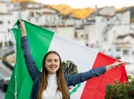 AFS student in Mexico holding the country flag