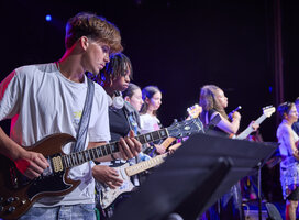 Participants playing musical instruments during concert