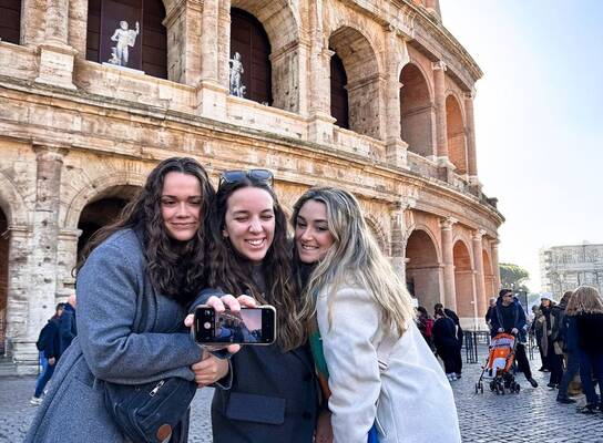 Students taking selfie in front of roman forum 