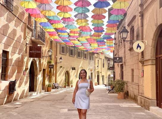 Student walking under an umbrella canopy in Barcelona