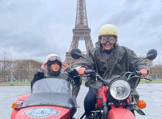 EF Gap Year students in Paris on a retro motorcycle and sidecar tour in front of the Eiffel Tower, experiencing the city in a fun and unique way.
