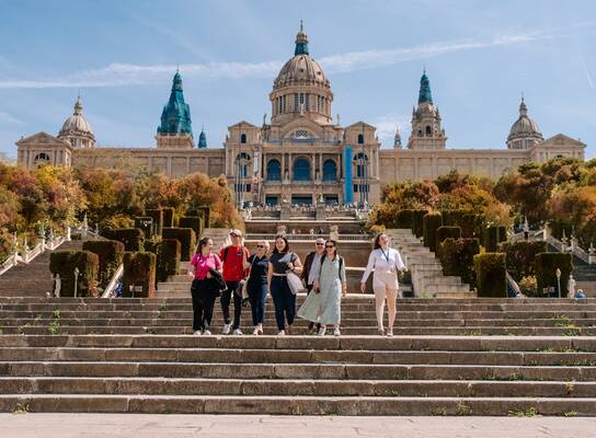 EF Gap Year students walking down the steps of the National Art Museum of Catalonia (MNAC) in Barcelona, Spain, enjoying a sunny day of art, history, and exploration.