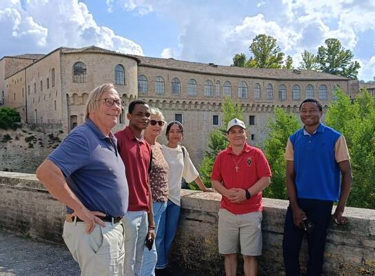 Students with the renowned Ducal Palace of Urbania in the background