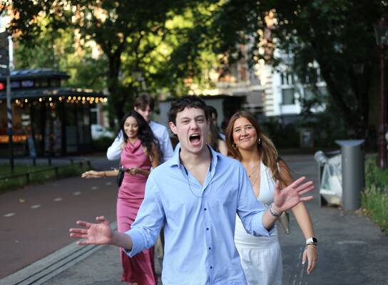Students walking through Amsterdam on their way to the graduation photoshoot during their study abroad program.