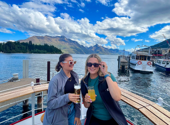 Two girls smiling on a boat in Queenstown