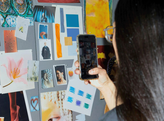 Student taking photo of mood board