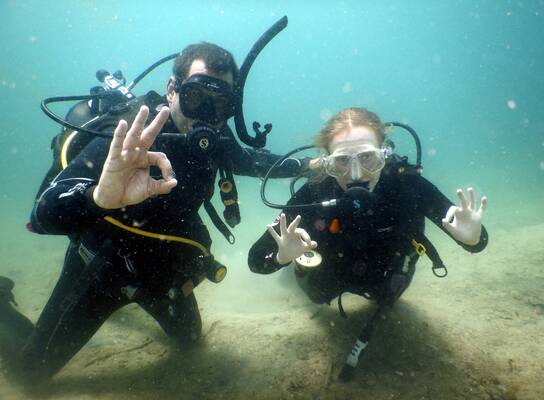Volunteers scuba diving together during a marine conservation program in southern Tanzania