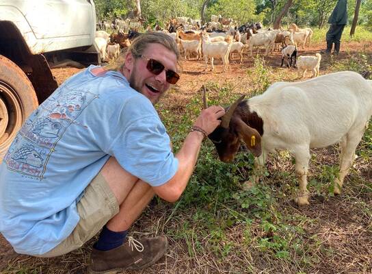 Volunteer with a goat