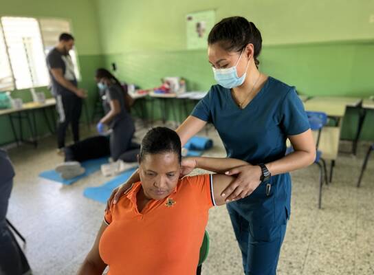 Nurse helping a Dominican Citizen