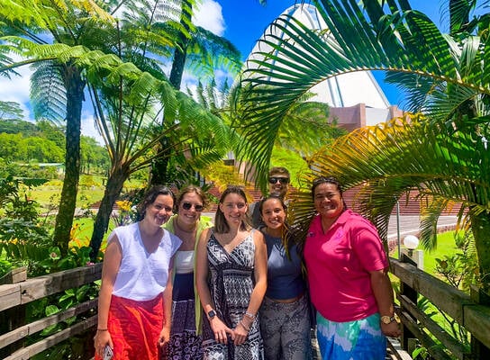 Students pose in front of a Bahai Temple