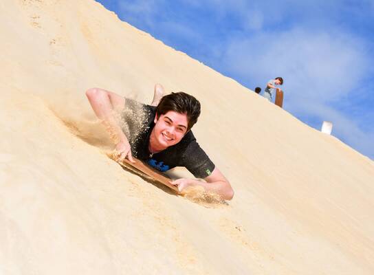Teen sandboarding in Australia
