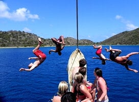 people jumping off boats