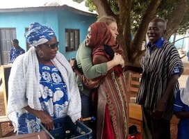 Volunteer hugging local child