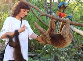 A woman helping a monkey in Peru