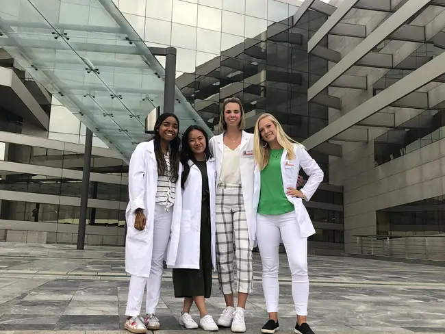 4 people wearing white coats