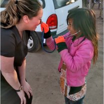 Bethany College Student teaching child how to use stethoscope