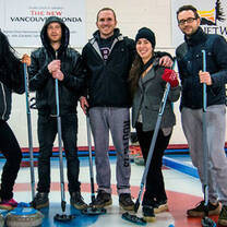 a group stands for a photo while curling