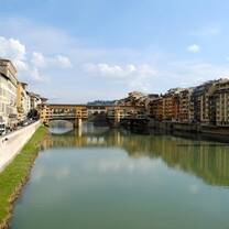 The Ponte Vecchio with clear skies and greenish water 