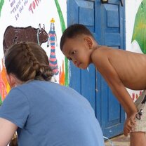 Volunteer painting a mural at local school Gap Year Volunteer Program Cambodia